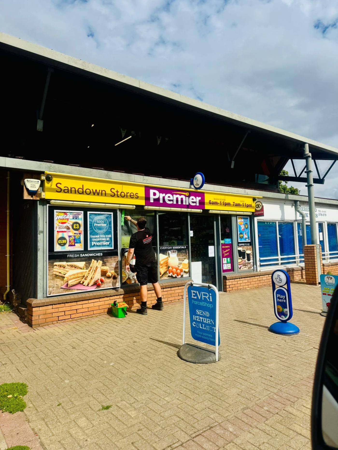 Lofty Cleans cleaning shopfront glazing at a Hereford convenience store