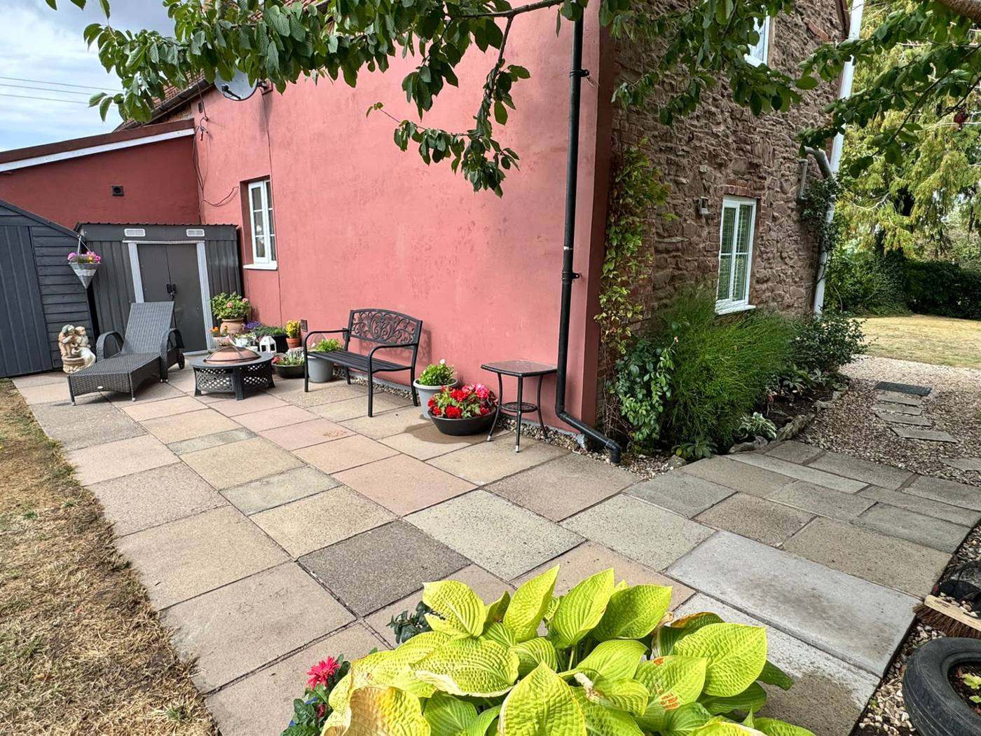 Patio paving being pressure washed